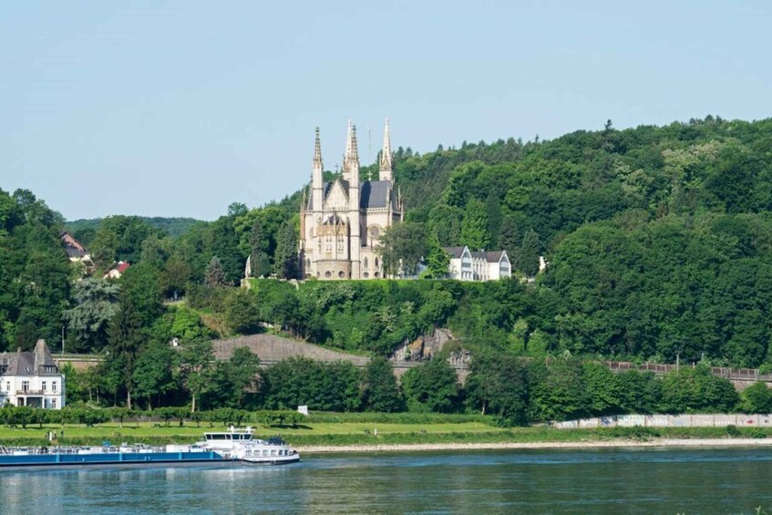 A castle on a hill, a river, and boats. 1