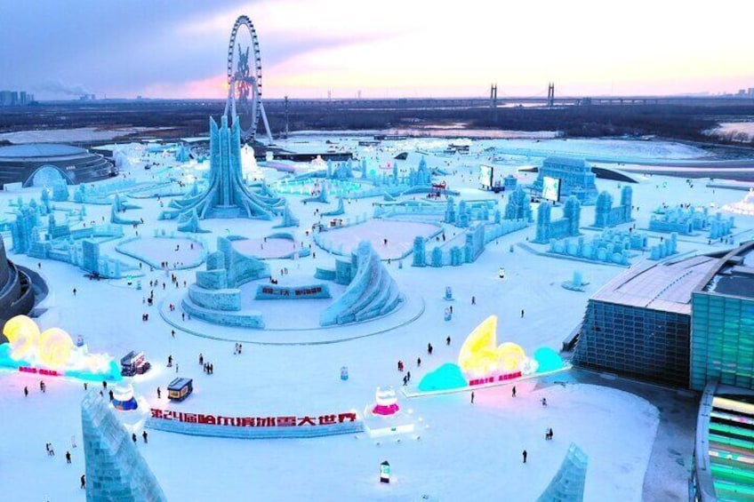 A winter scene with a large ice sculpture park, a Ferris wheel, and a building with a glass facade. 1