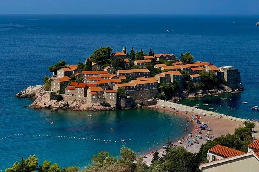 A coastal town with buildings, a beach, and the sea. 3