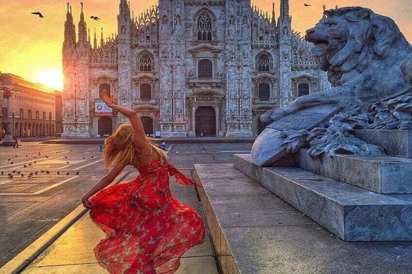 A person in a red dress, a lion statue, and a grand cathedral. 3