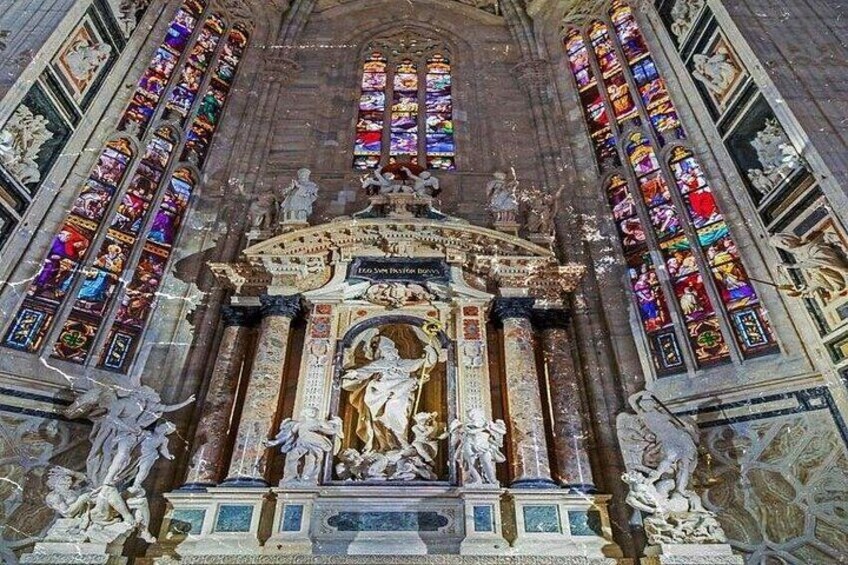 A grand cathedral interior with ornate stained glass windows, detailed sculptures, and a central altar. 4