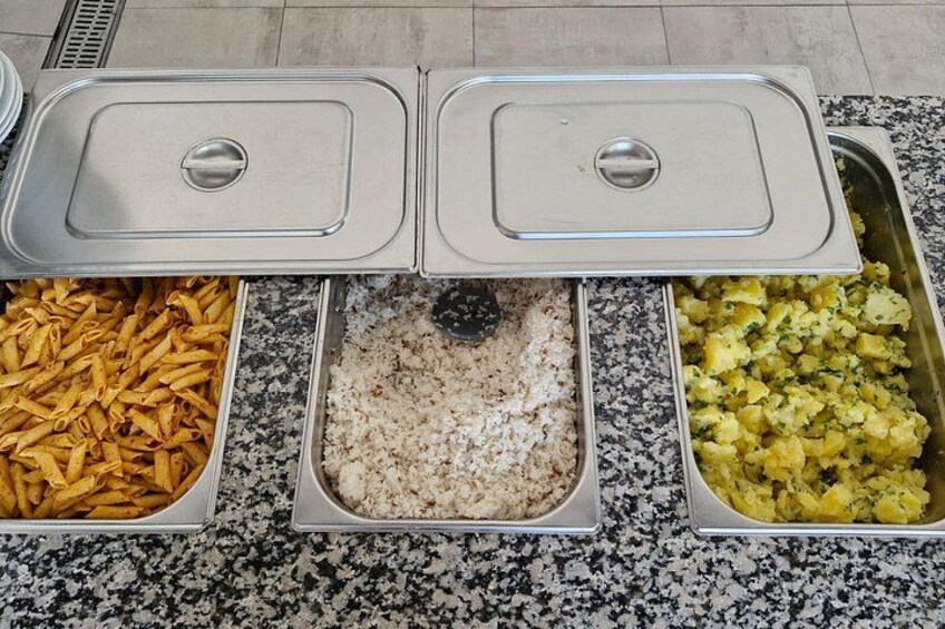 A buffet with three food stations: French fries, rice, and mashed potatoes. 3