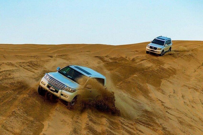 Two off-road vehicles in a desert landscape. 4