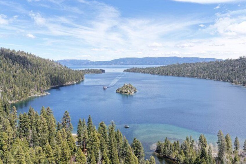 A large body of water surrounded by dense forests and distant mountains. 2