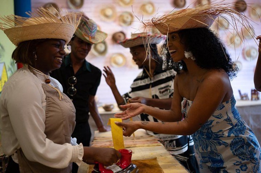 People wearing straw hats and engaging in a transaction at a market stall. 2