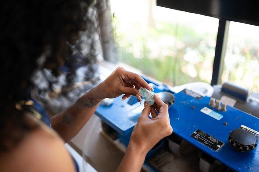 A person working on a blue electronic device with a mouse and a power strip. 4