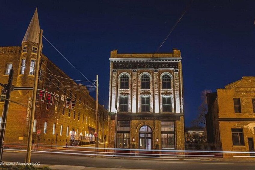 A historic building with a clock tower and arched windows at night. 1