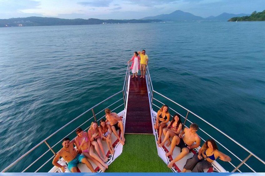 A boat with people on a pier, surrounded by water and distant mountains. 2