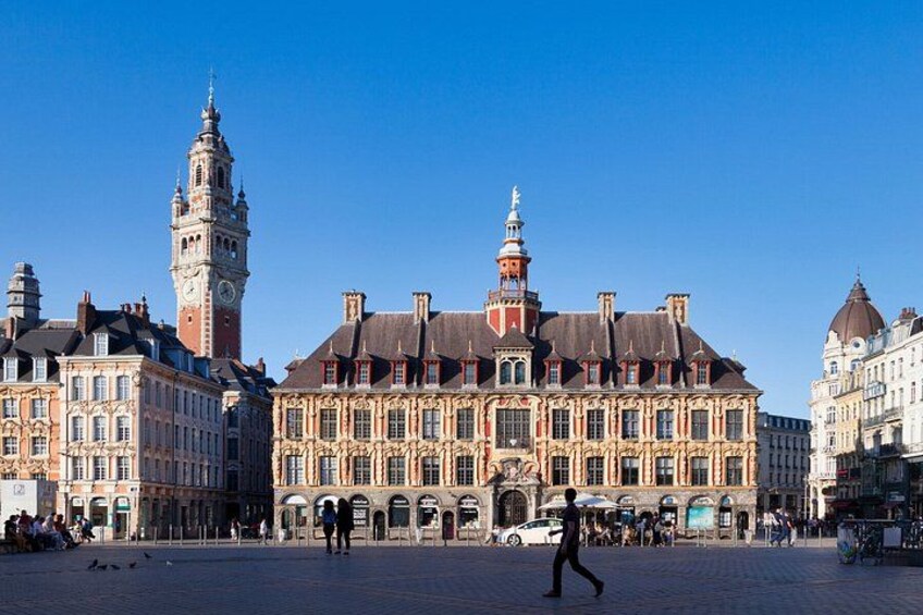 A historic building with ornate architecture, a clock tower, and a clear blue sky. 4