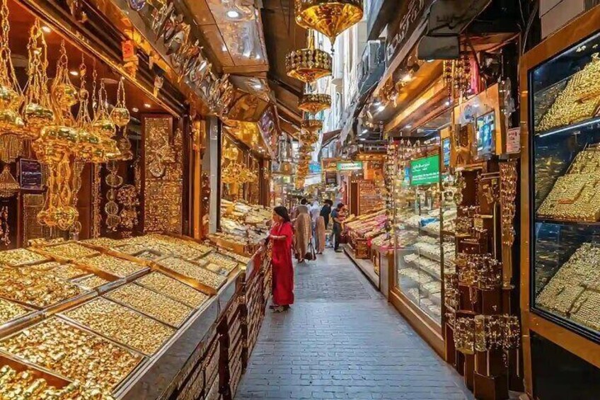 A jewelry store with glass display cases filled with gold jewelry. 4