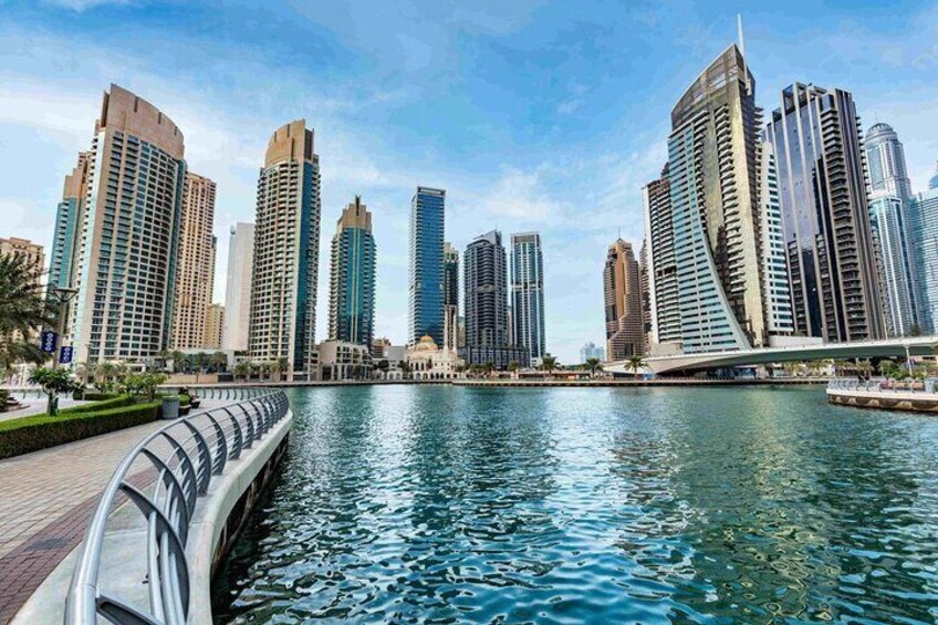 A city skyline with modern high-rise buildings along a waterfront. 5