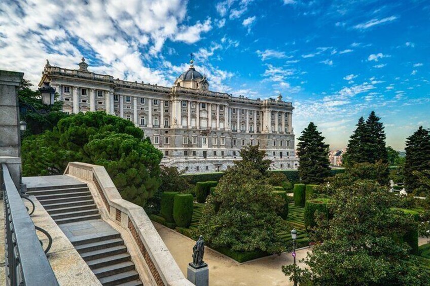 A grand building with a dome, surrounded by well-manicured gardens and a staircase. 5