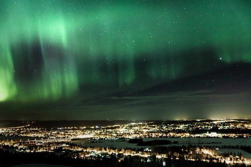 The Northern Lights over a cityscape at night. 2