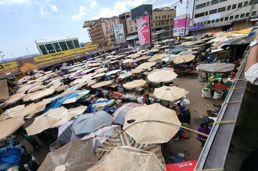 A crowded outdoor market with numerous stalls and umbrellas. 2