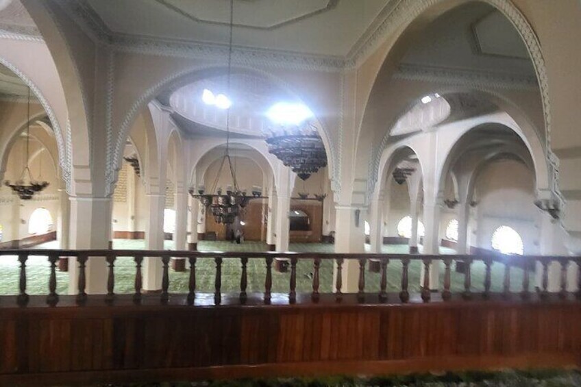 An interior with arched ceilings and a wooden railing. 3