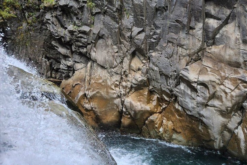 A waterfall cascading over rocky terrain. 4