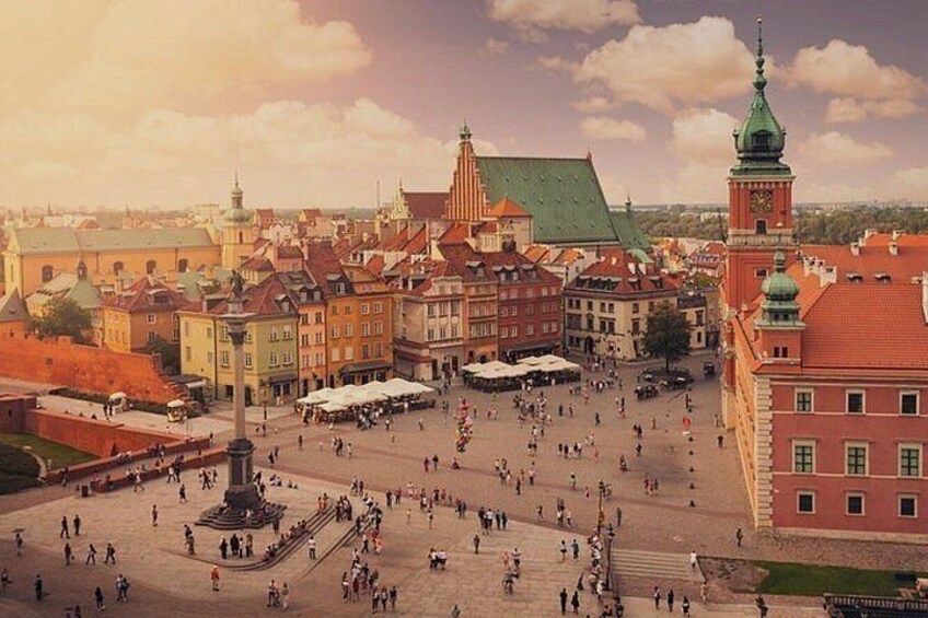 A historic square with a central monument, surrounding buildings, and a prominent tower. 4