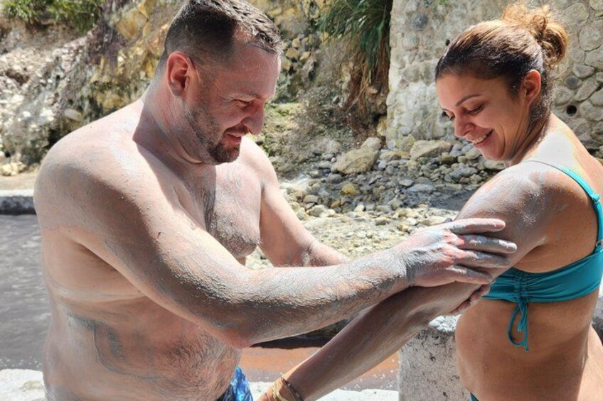 Un hombre y una mujer junto a una piscina, con agua y rocas al fondo. 2
