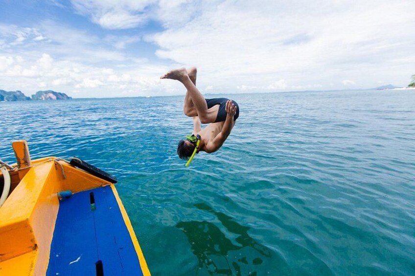 A person diving off a boat into the ocean. 1