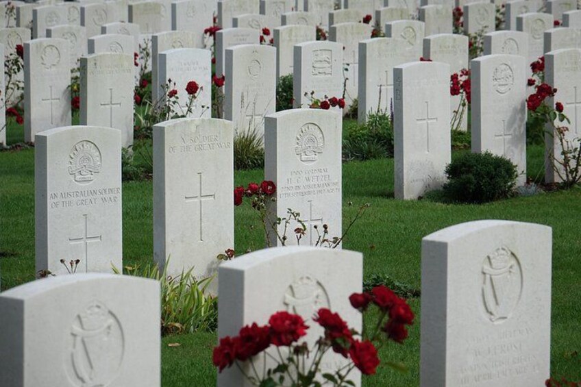 A cemetery with numerous headstones, some with crosses and others with inscriptions. 3