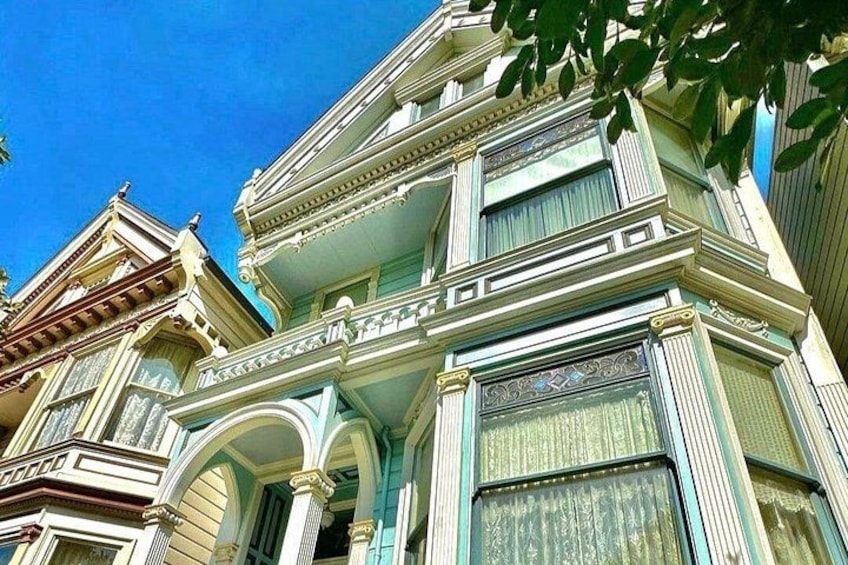 A historic building with ornate architectural details, including a balcony and decorative window frames. 2