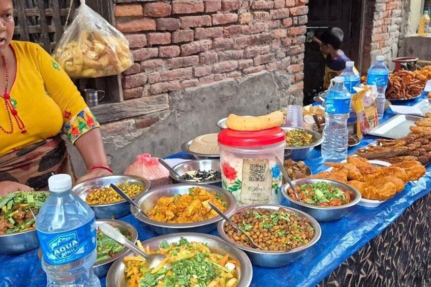A table with various food items and containers, likely at a market or food stall. 2