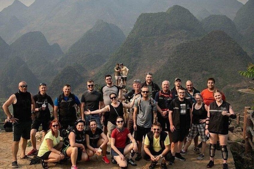 A group of people posing in a mountainous landscape. 5