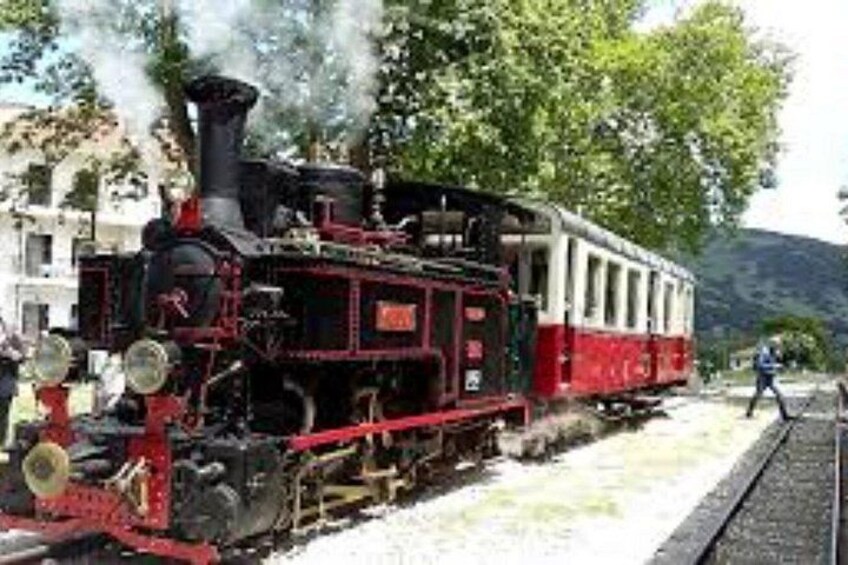 A steam locomotive with a red and white passenger car. 3