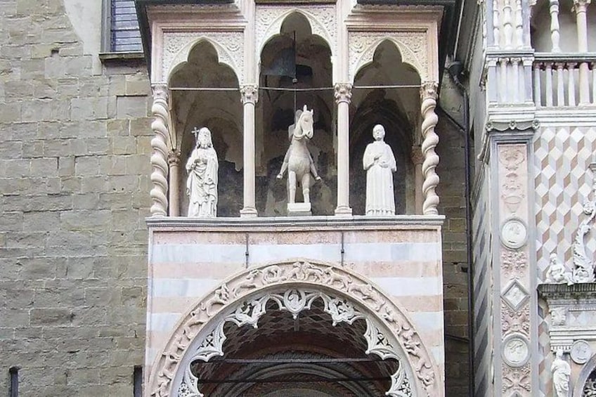 A stone building with ornate carvings and statues of religious figures. 4