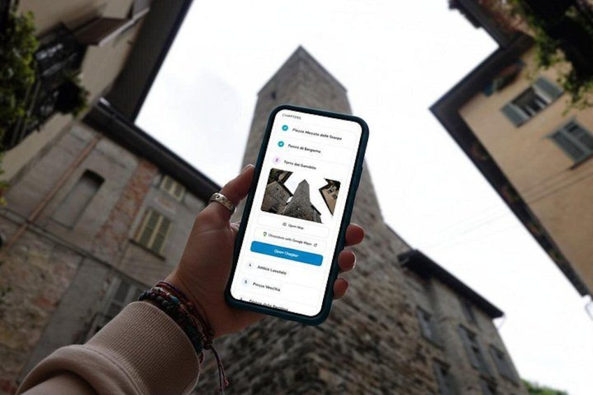 A person holding a smartphone with a travel app displaying a list of places. 5