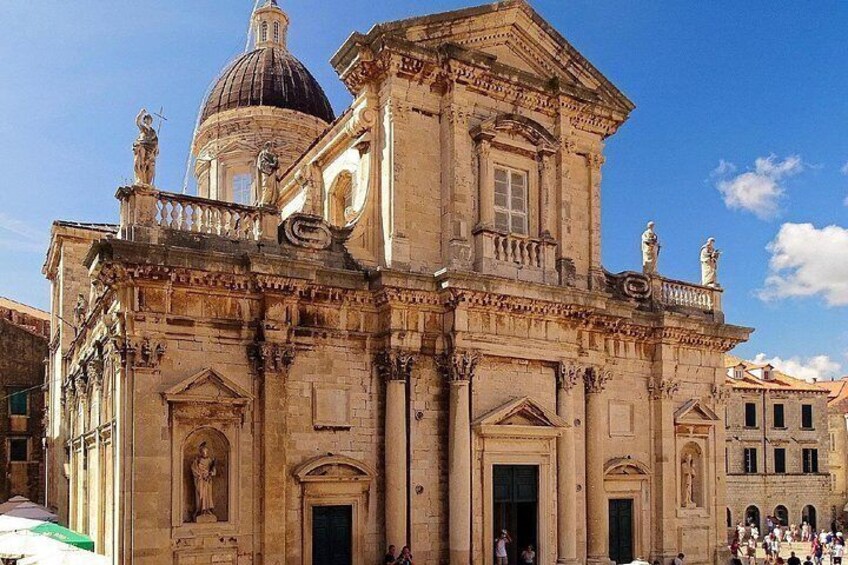 A historic building with a dome, statues, and classical architecture. 3