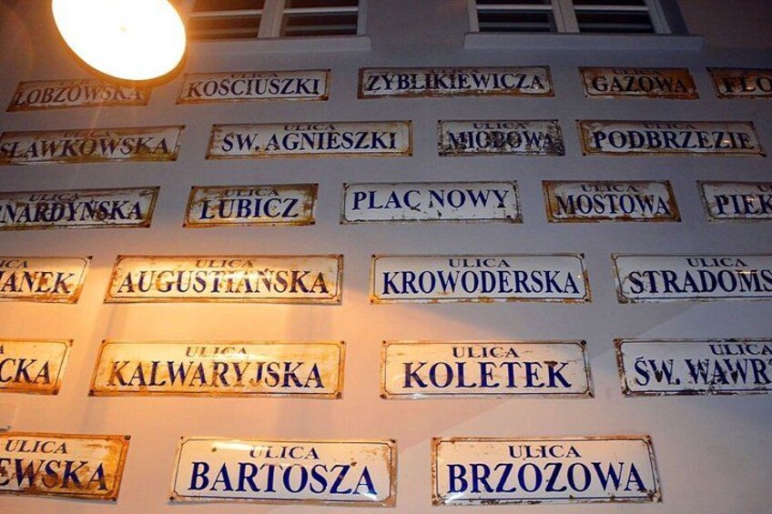 A wall with multiple street signs. 2