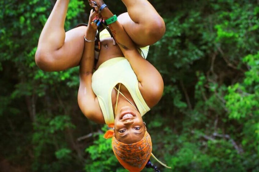 A person upside down in a forested area. 1
