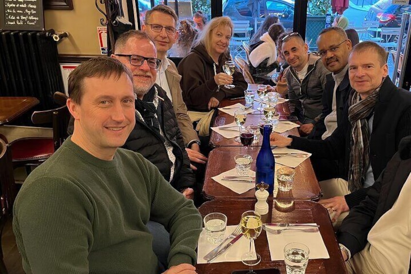En grupp människor sitter runt ett bord på en restaurang. 5