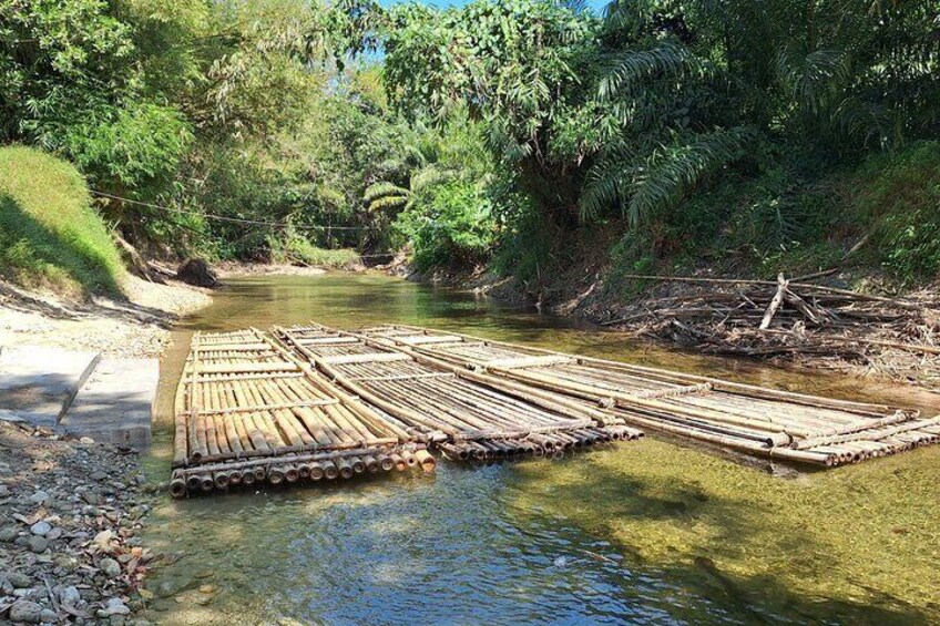 A bamboo raft on a river surrounded by lush greenery. 4