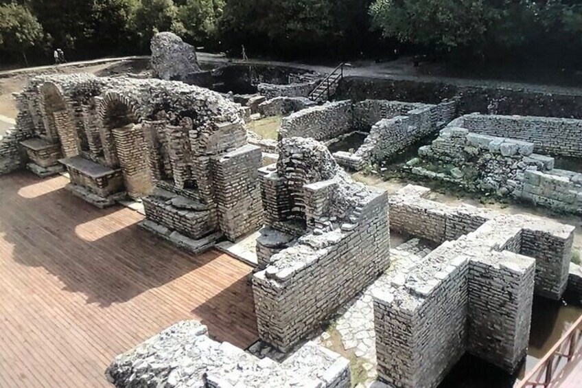 Ancient stone ruins with brick structures and a paved walkway. 5