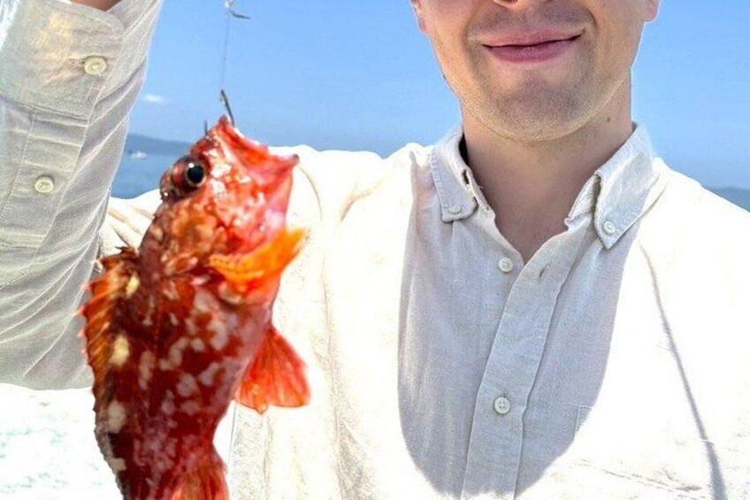 A person holding a fish. 4
