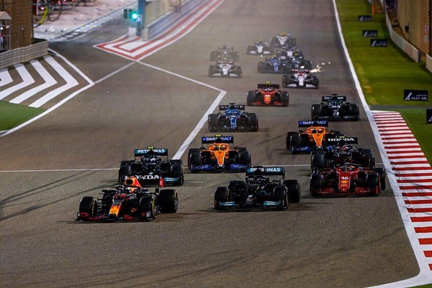 A racing event with multiple cars on a track. 1