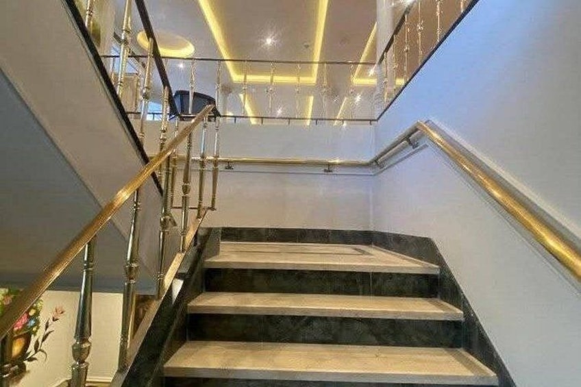 A staircase with marble steps and a glass railing. 3