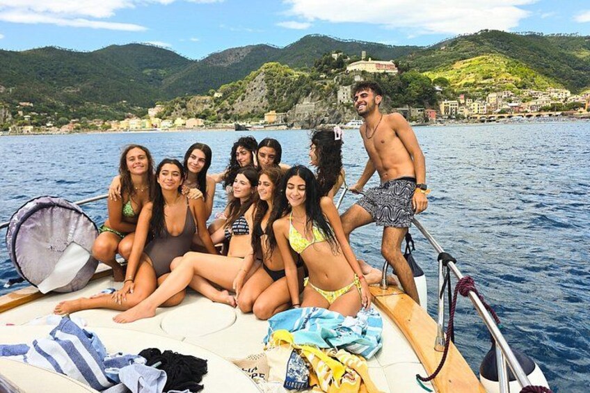 A group of people on a boat with a mountainous landscape in the background. 4