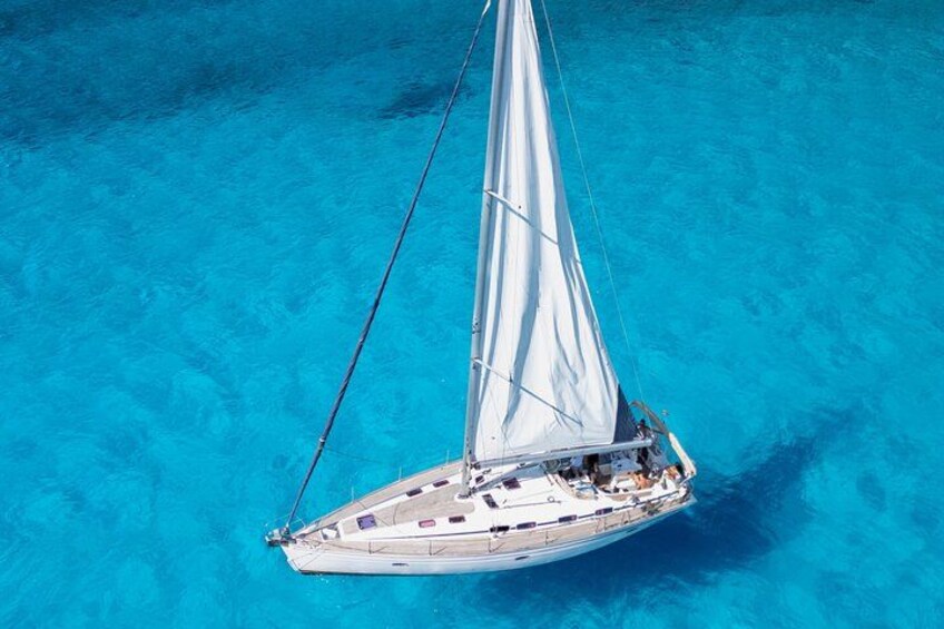 A sailboat on turquoise water. 1