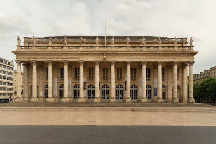 A large classical building with columns and statues. 2