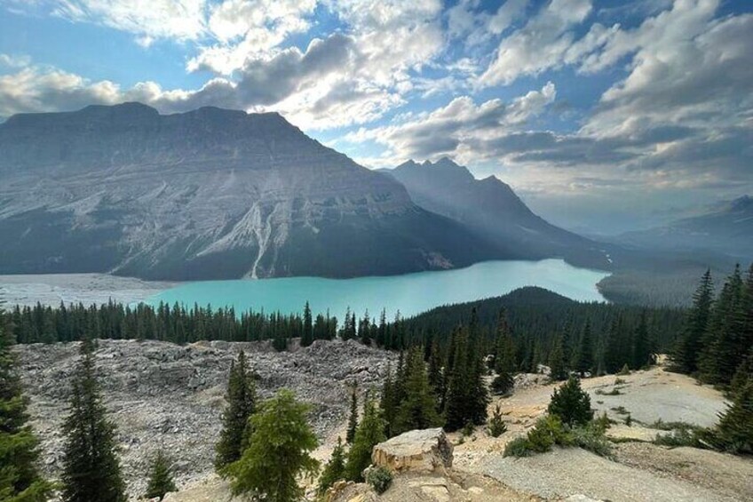 Un paisaje montañoso con un lago turquesa y un bosque denso. 5