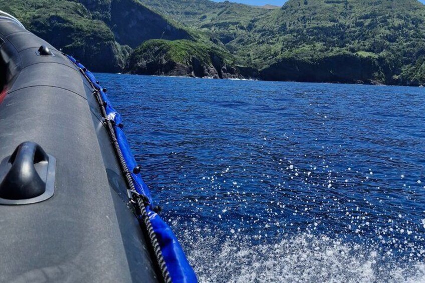 A boat on water with a mountainous landscape in the background. 2