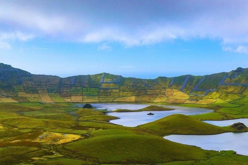 A mountainous landscape with green valleys and a river. 1