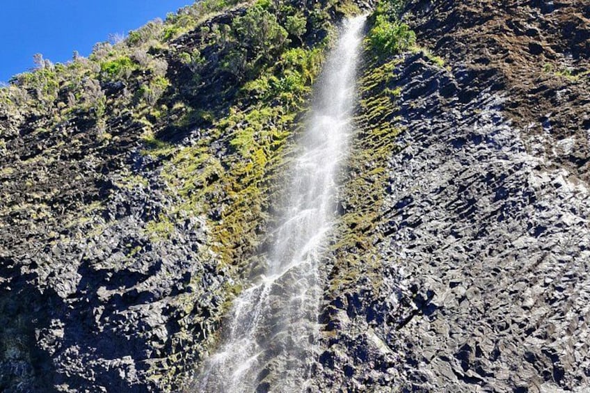 A waterfall cascading down a rocky cliff. 2
