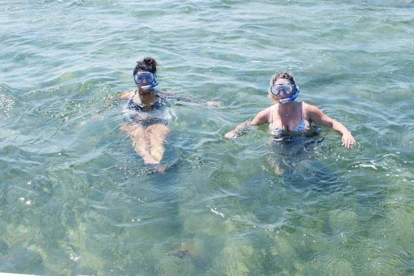 Two people snorkeling in clear water. 3