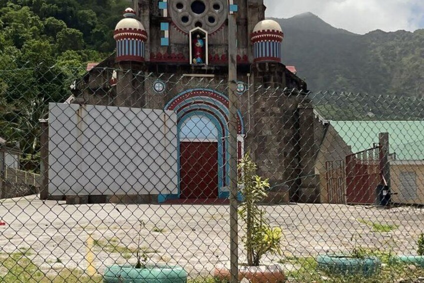 A church with a large arched entrance and two domed towers. 4
