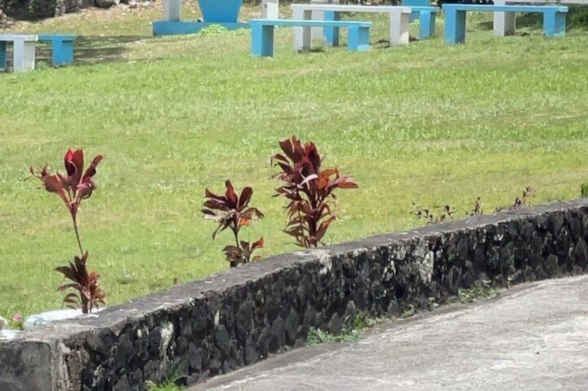 A cemetery with headstones and a stone wall. 5