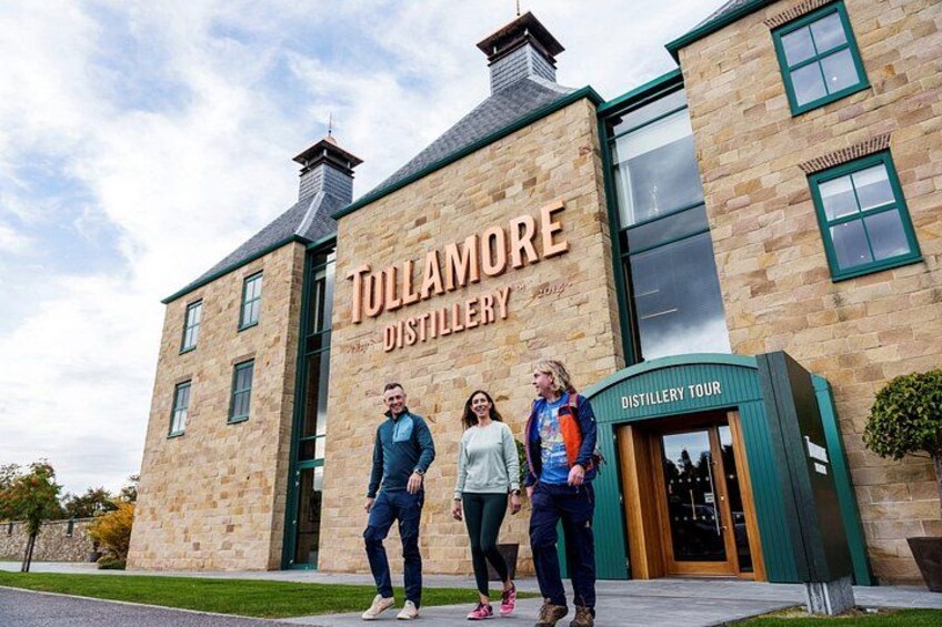 A building with a sign that reads 'Tullamore Distillery.' 2